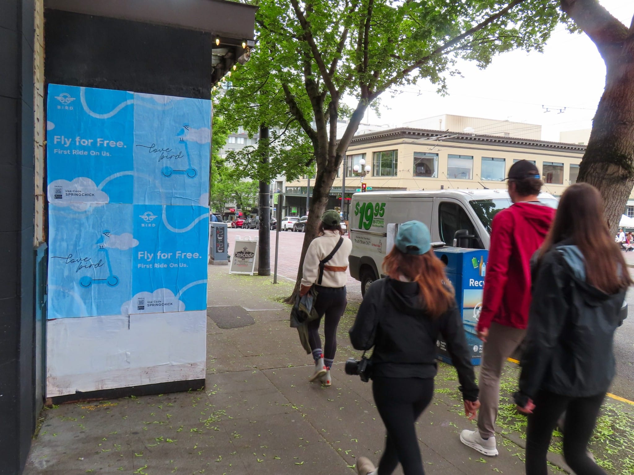 Bird Wild Posting® street posters promoting free scooter rides at a pedestrian-heavy urban sidewalk