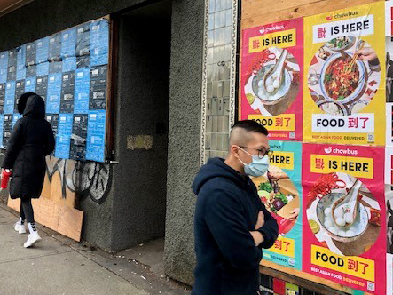 Chowbus wheat pasted posters displayed along a Vancouver sidewalk in an urban neighborhood