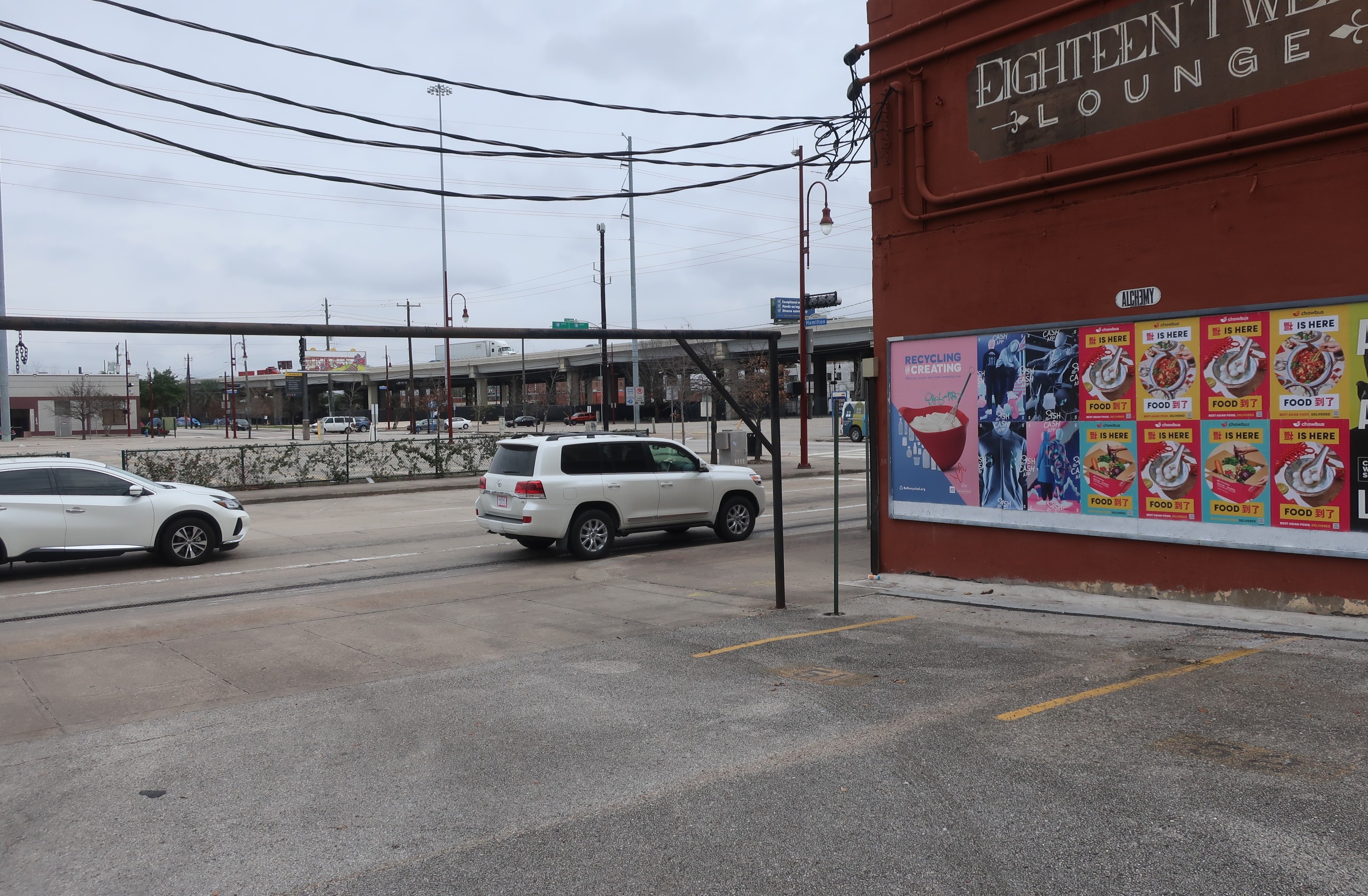 Chowbus Wild Posting® posters installed along a Houston street near a busy intersection