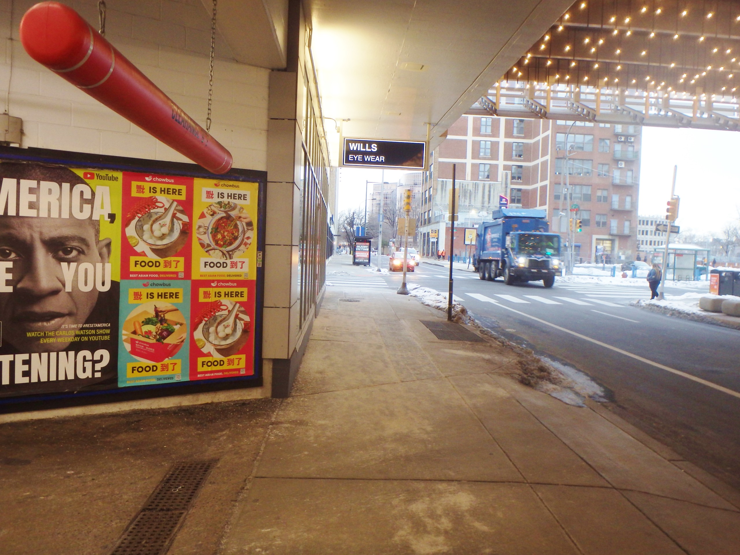 Chowbus Wild Posting® posters displayed on a Philadelphia storefront wall along a busy downtown sidewalk