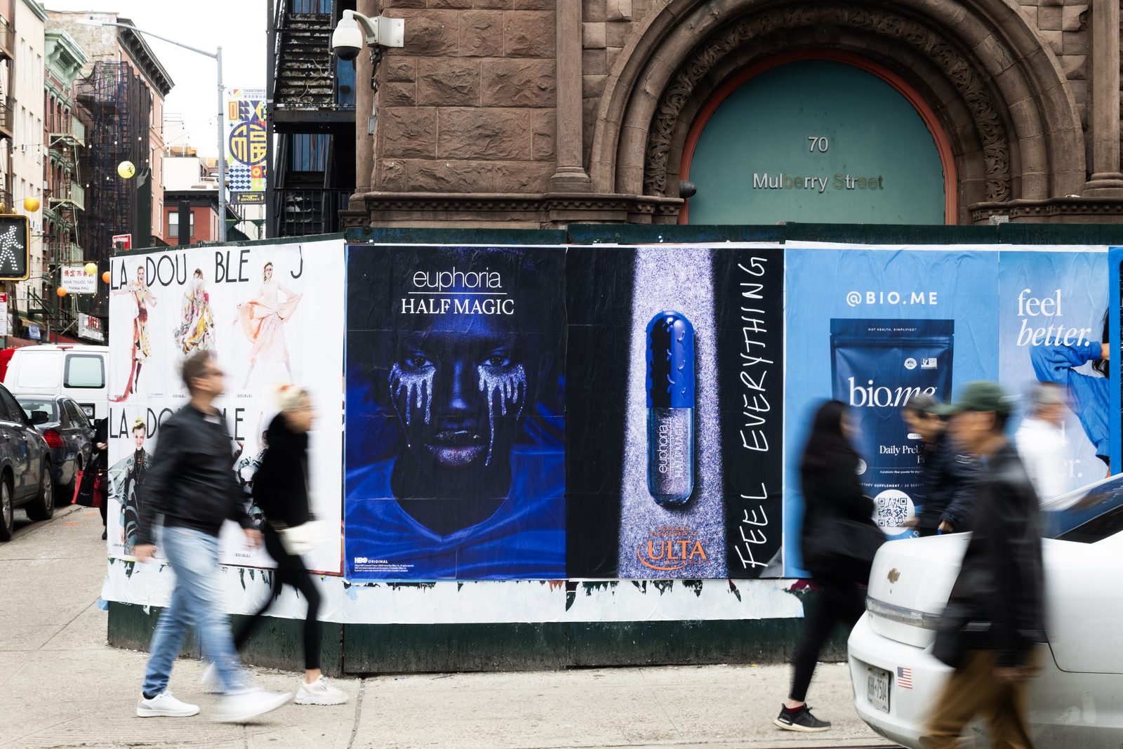 Half Magic Beauty Euphoria collection Wild Posting® on Mulberry Street in New York City, with pedestrians passing by