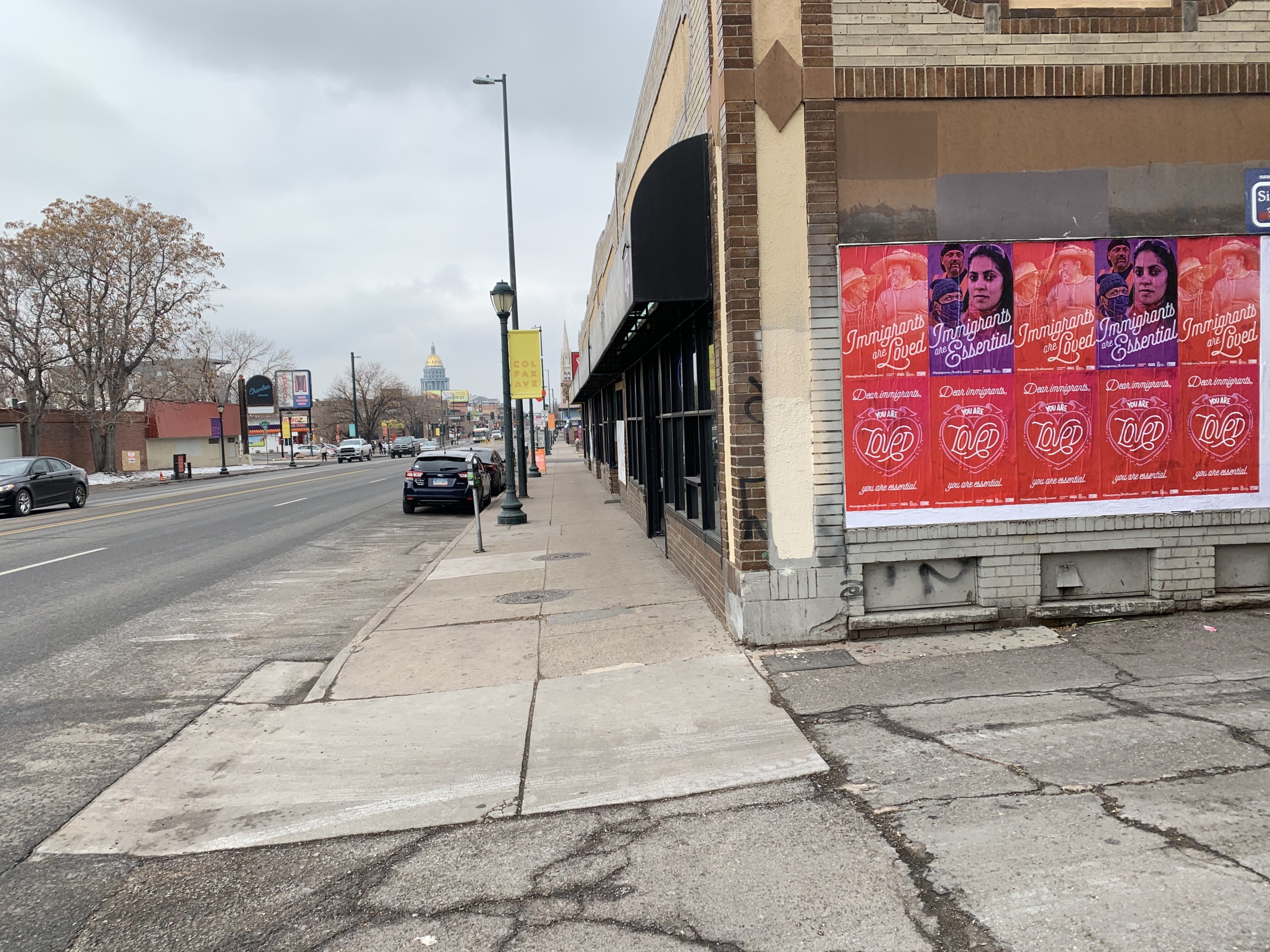 Street poster campaign in Denver featuring the message “Immigrants are Loved” and “You Are Loved, You Are Essential.”