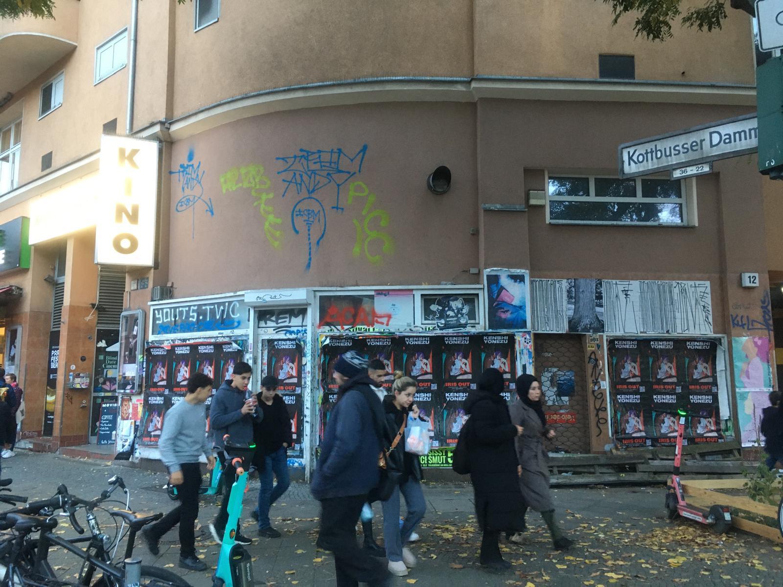 Kenshi Yonezu Wild Posting® takeover along Kottbusser Damm with dense pedestrian traffic in Berlin