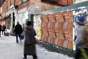 Rose & Co Wild Posting® Mock – Urban Street Scene 🌟 WILD POSTING® A series of Rose & Co eyewear posters displayed on a gritty New York street wall, surrounded by pedestrians in motion blur.