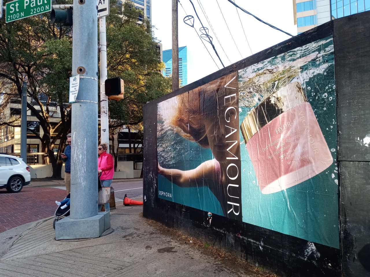 Vegamour Wild Posting® wallscape installed at a high-traffic street corner with pedestrian visibility