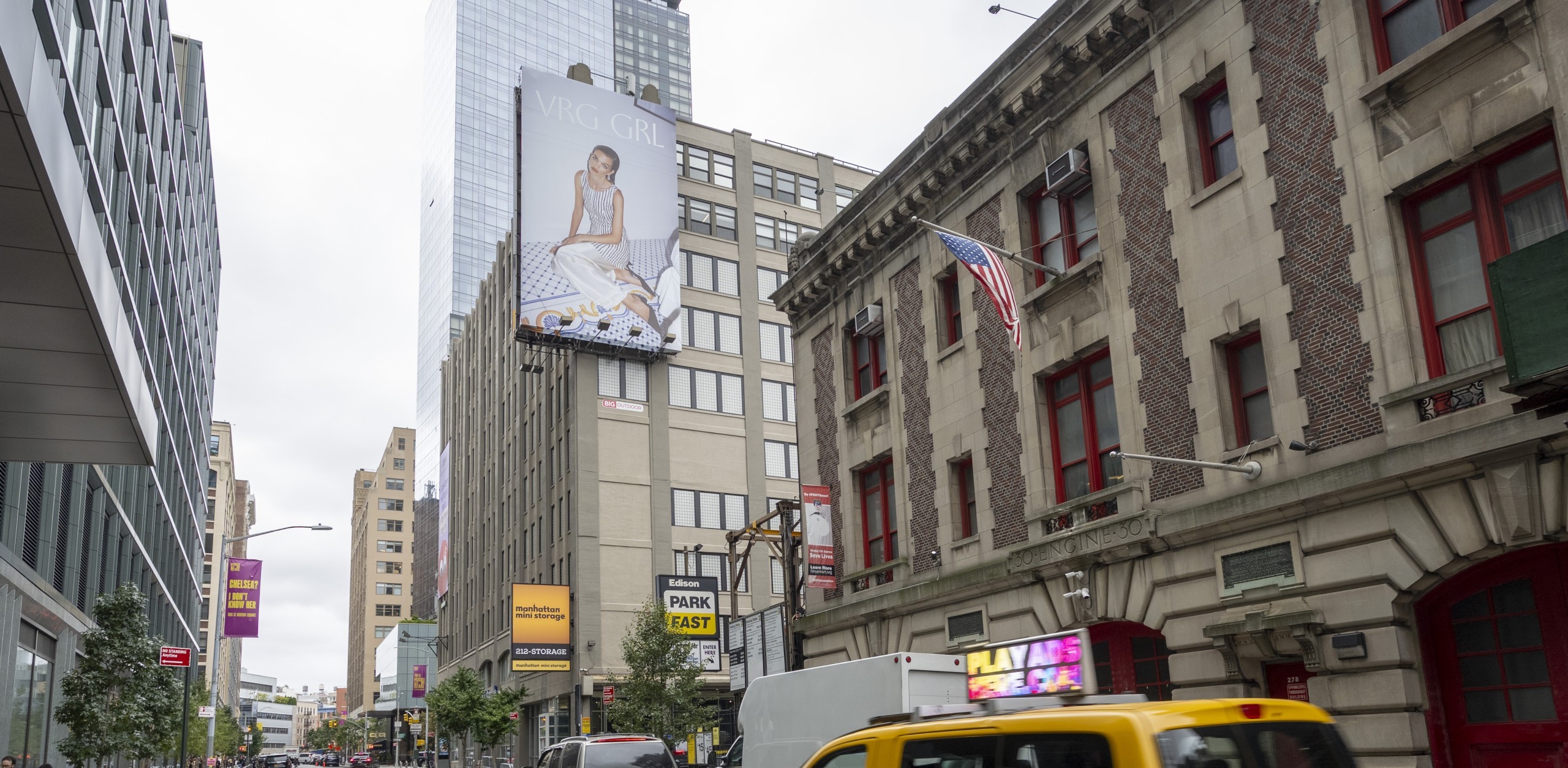Large-format VRG GRL billboard displayed above traffic at Spring St and Varick St in NYC