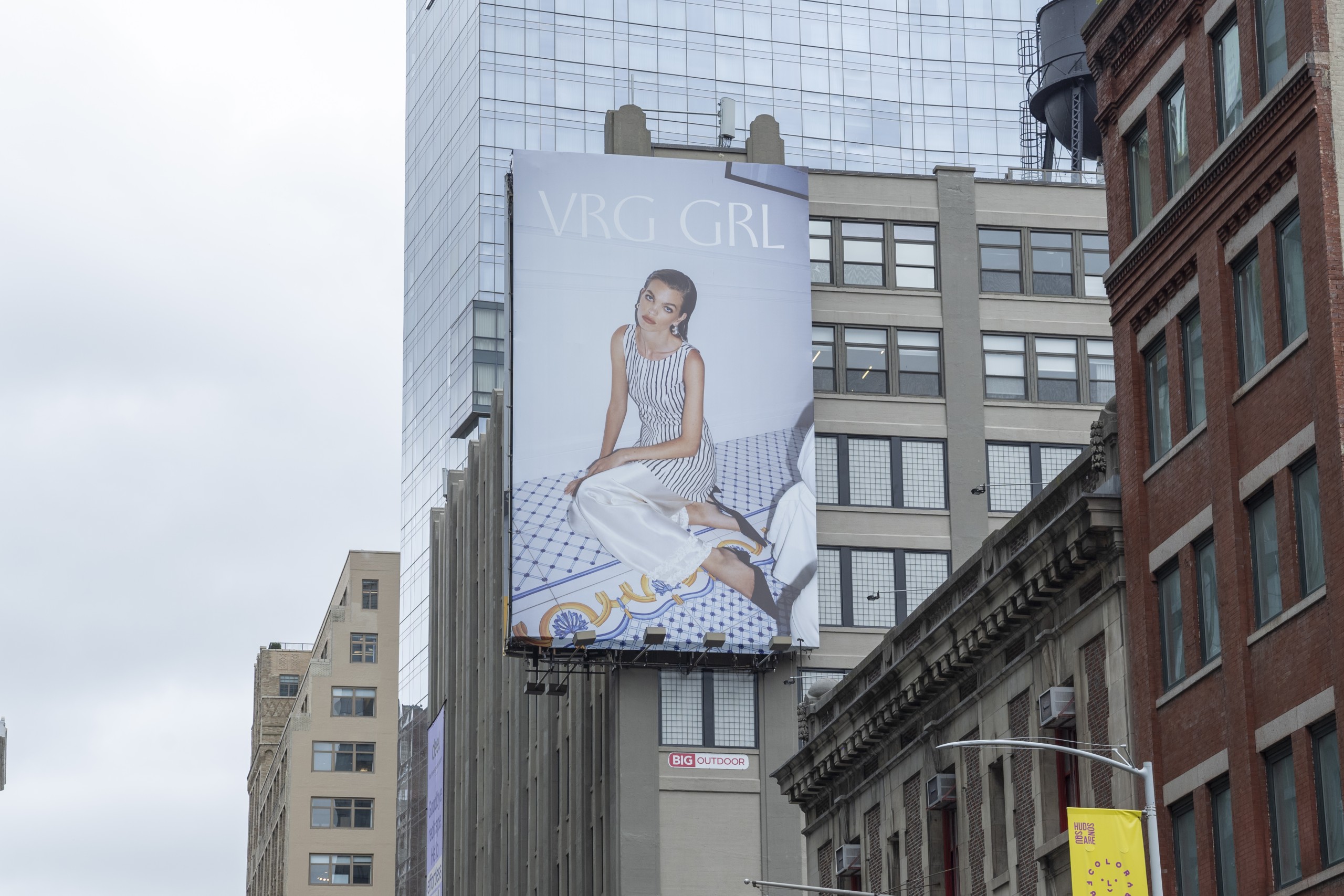 VRG GRL fashion billboard displayed on a Midtown Manhattan building at Spring Street and Varick Street in New York City