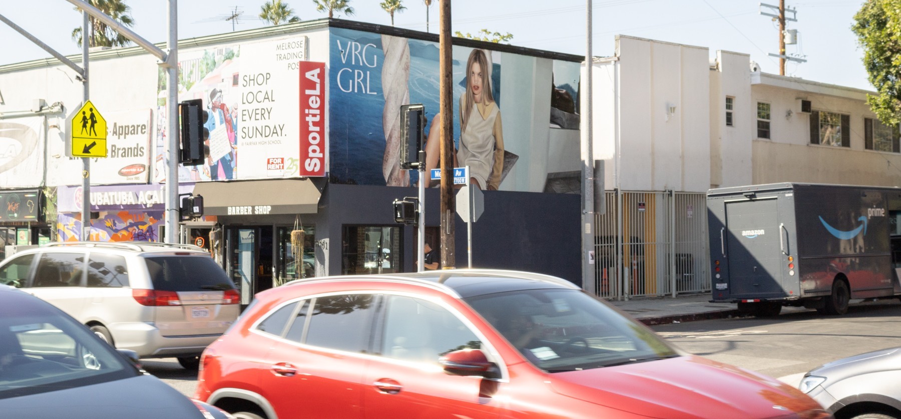 VRG GRL fashion billboard at a busy Melrose Avenue intersection in Los Angeles