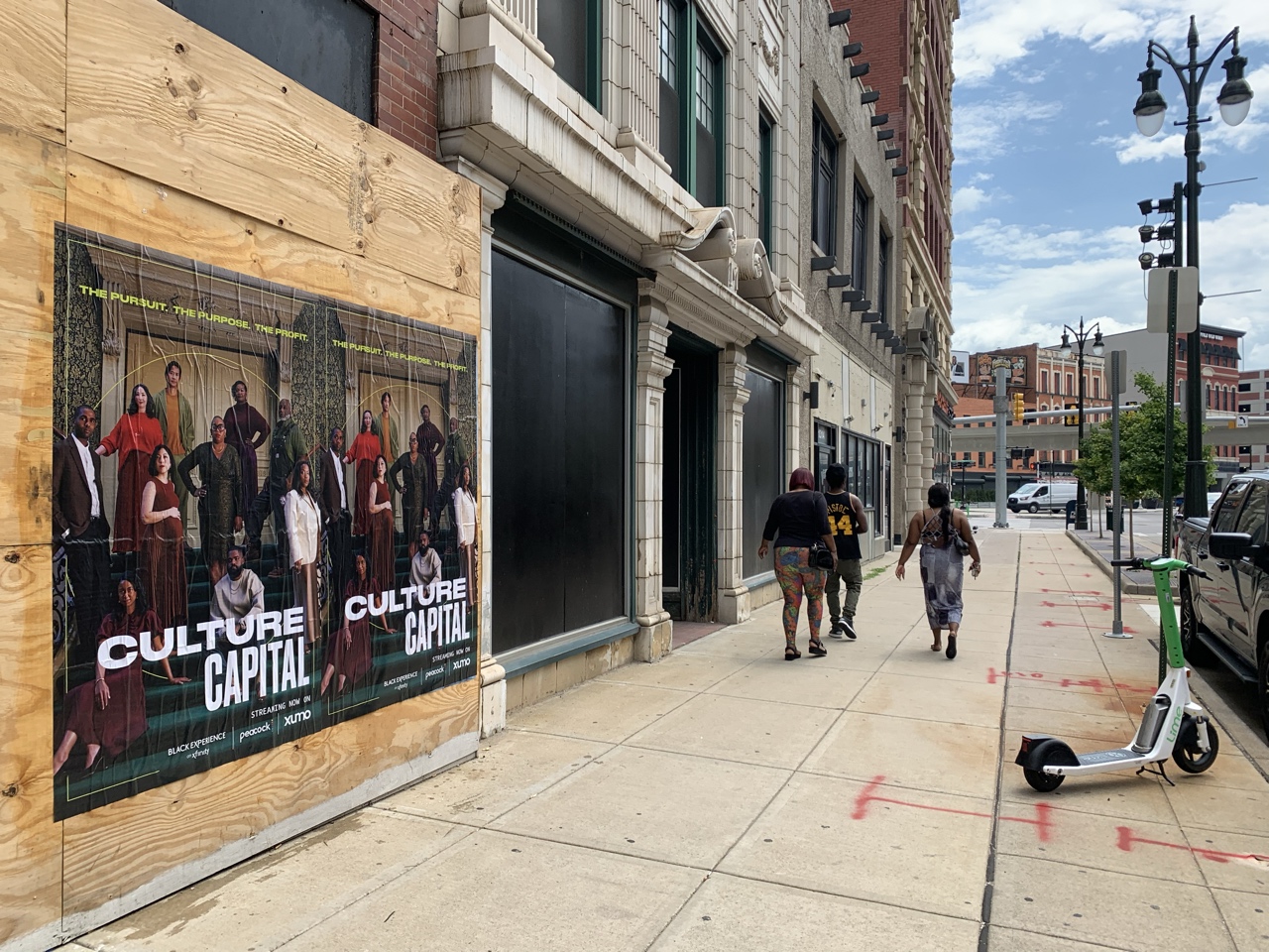 Wild Posting® campaign installed on plywood construction panels along Broadway Street in Downtown Detroit, Michigan.