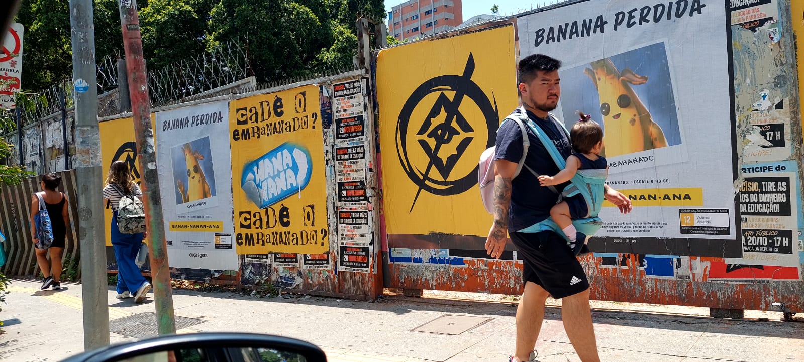 Wild Posting® urban wall campaign in São Paulo, Brazil featuring large-format street posters installed along a high-traffic pedestrian corridor.