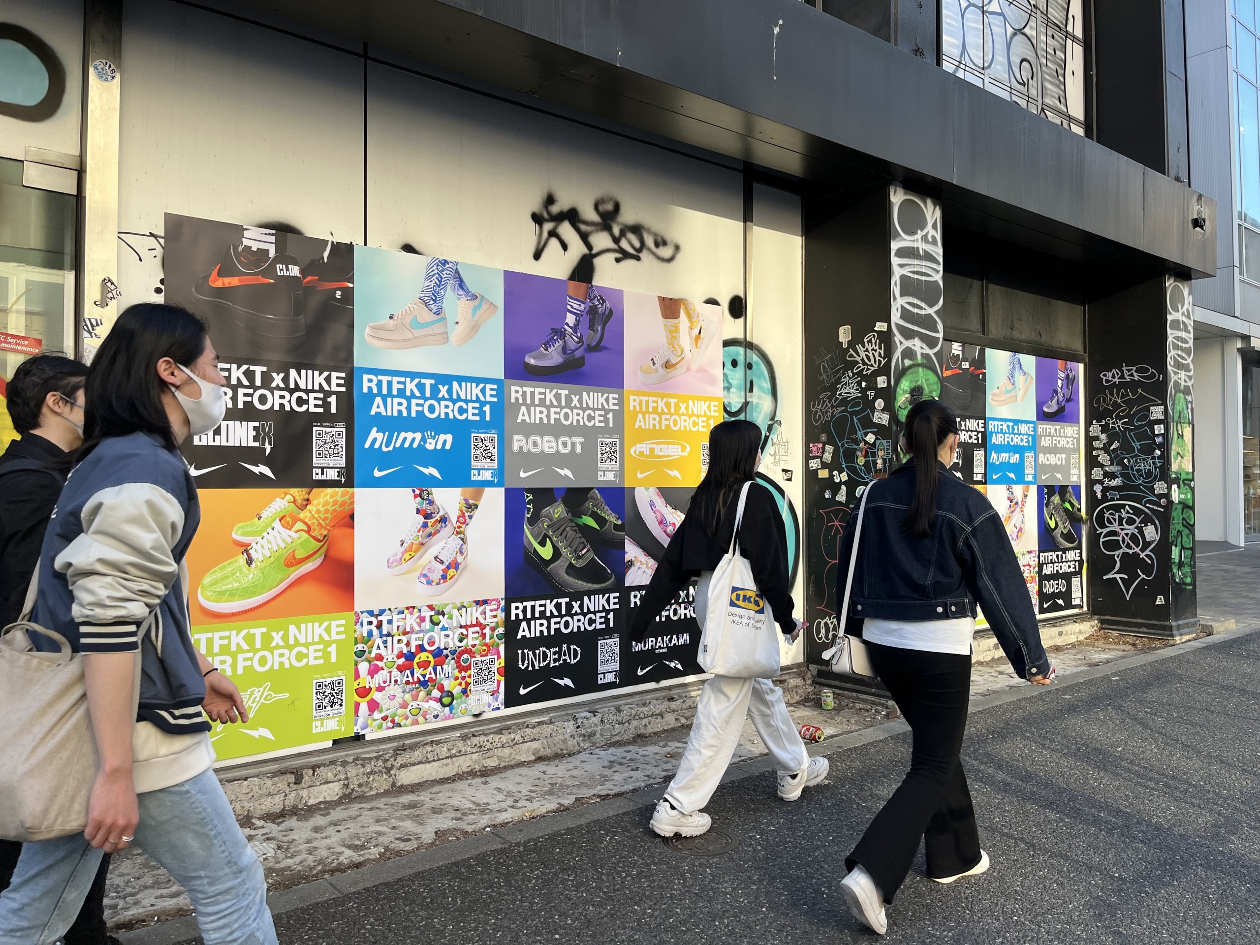 Wild Posting® posters in Tokyo featuring a Nike x RTFKT campaign placed along a high-foot-traffic urban sidewalk